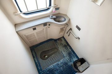 Naklejka premium Squat toilet onboard a Chinese overnight sleeper train