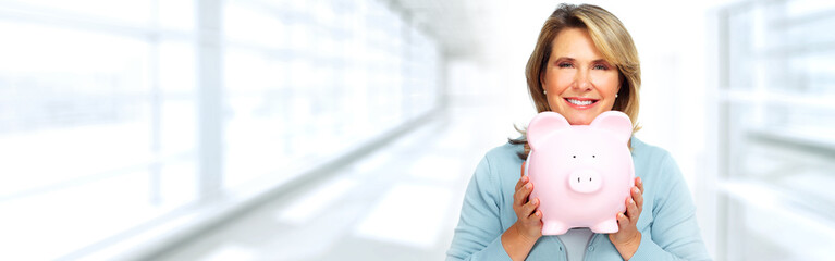 Mature woman with piggy bank.