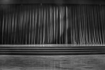 Black and white curtains and wooden stage.
