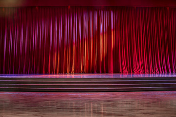 Red curtains and wooden stage.