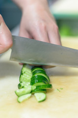 Chef cutting cucumber with skillfully and cutting fast