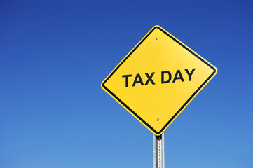 tax day text on road warning sign