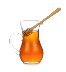 Jar of honey with wooden drizzler isolated on white background