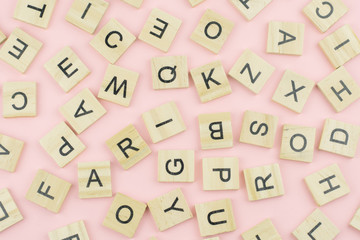 background of  letterpress wood type printing blocks, random letters of alphabet and punctuation stained by black inks