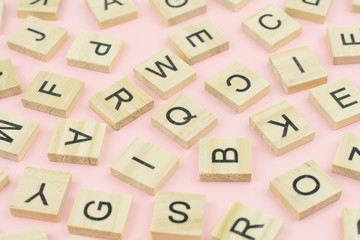 background of  letterpress wood type printing blocks, random letters of alphabet and punctuation stained by black inks