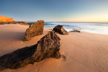 A rocky shoreline sunset