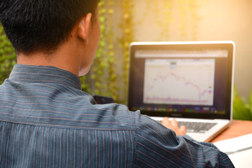 Close-up of business man typing on a laptop.