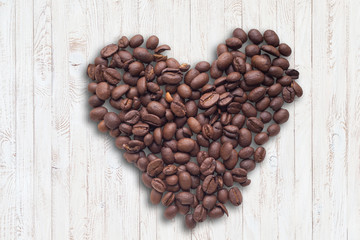 Coffee beans in form of heart on beautifull background. Love. Insparation. On wooden background.