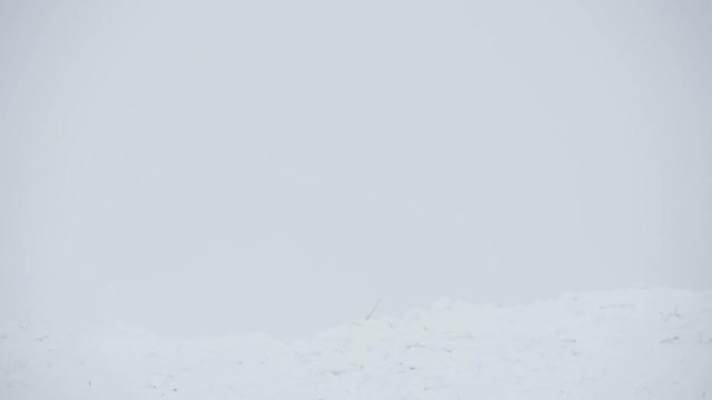 Snowboarder jumping through air with deep blue sky in background