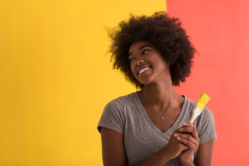 black woman painting wall