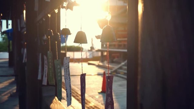 Bells moved by wind at sunset at Kiyomizu-dera Kyoto Japan backlight