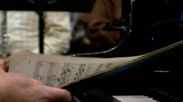 Rehearsal of the symphonic orchestra, page turning with notes