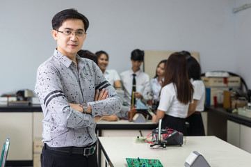Portrait of Asian teacher in front of College Students in the laboratory classroom, University education concept
