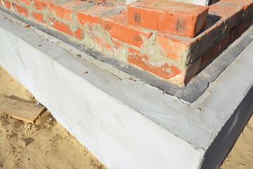 Damp proof membrane on top of foundation walls. Bitumen waterproof membrane for house foundation...