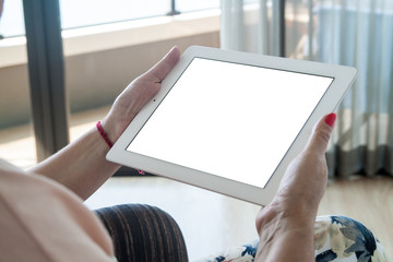 A woman is holding a white tablet