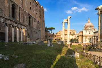 Fototapeta na wymiar Rome, Italy. Roman Forum, from left to right: Portico of Twelve Gods, Tabularia (Palace of Senators), Temple of Vespasian, in the background Mamertinum (Church of San Pietro in Carzere)