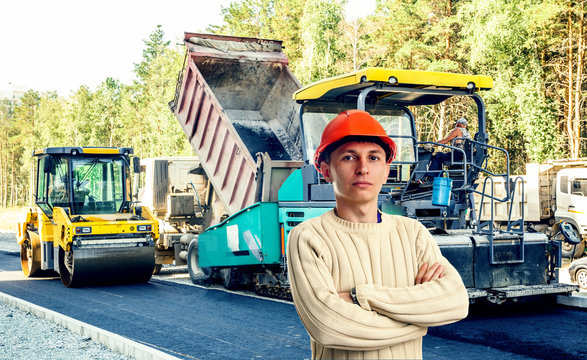 Workman with asphalt-placing machine