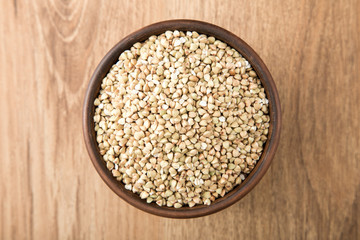green buckwheat on wooden table. Healthy diet concept food