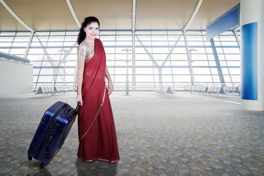 Indian woman walks in airport terminal