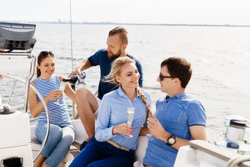 Group of happy friends having a party on a yacht and drinking champagne.  Vacation, holiday,...