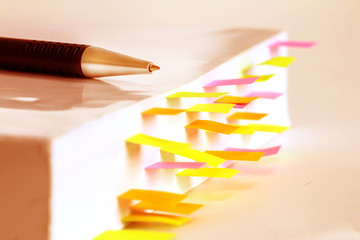 Close up White book marked by sticky note