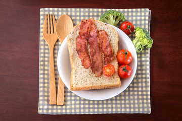 breakfast with bread and bacon in white dish