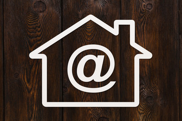 Paper house with email sign inside. Abstract conceptual image