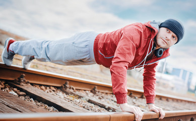 Young sportsman during his training outdoors. Sport, fitness, street workout concept