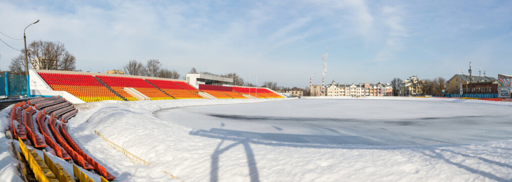 Tribunes of stadium after a strong snowfall. Stadium for game in football soccer .