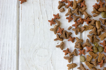 Pets food on white wooden table.