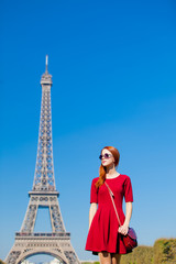 Fototapeta na wymiar beautiful young woman on the Eiffel Tower background