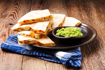 Quesadilla with chicken, served with guacamole or salsa sauce.
