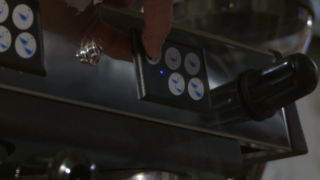 Making coffee in electric coffe machine in a cafe