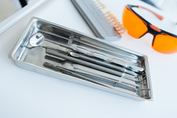 Dental tools on a white table.