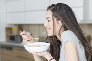 Morning scene. Happy Woman Having Healthy Breakfast cereal