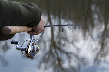 Fishing in river.A fisherman with a fishing rod on the river bank. Man fisherman catches a fish