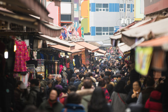 A crowd of people in the traditional Asian market.