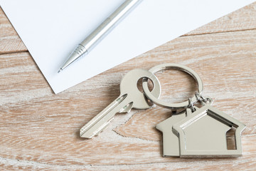 House shape keys and pen on a wooden background