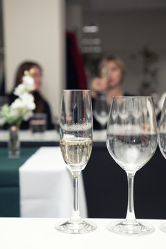 Sparkling wine to the wine glass. Serving table prepared for event party or wedding. Soft focus, selective focus. Toned.