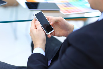 Close up of a business man using mobile smart phone