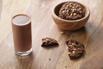 chocolate milk in glass with homemade chocolate cookies with hazelnuts, sweet breakfast