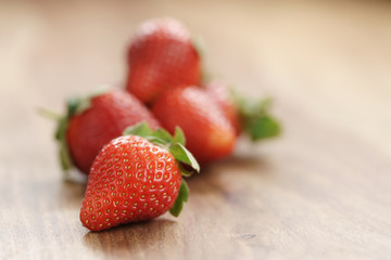 fresh strawberries on old wooden background with copy space, organic berries