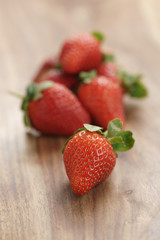 fresh strawberries on old wooden background vertical, organic berries