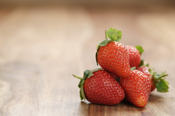 fresh strawberries on old wooden background with copy space, organic berries