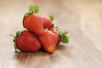 fresh strawberries on old wooden background with copy space, organic berries