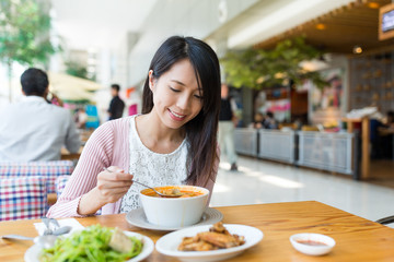 Woman enjoy her food at restaurant