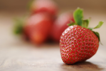 fresh strawberries on old wooden background with copy space, organic berries
