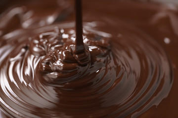 macro photo of premium dark chocolate pour in bowl, shallow focus