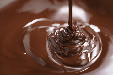macro photo of premium dark chocolate pour in bowl, shallow focus