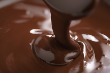 macro photo of premium dark chocolate pour in bowl, shallow focus